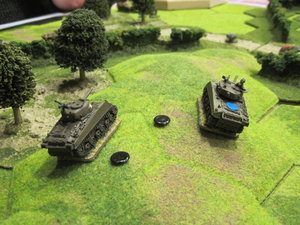The Shermans await the German counter attack and the Firefly destroys two of the German armoured vehicles
