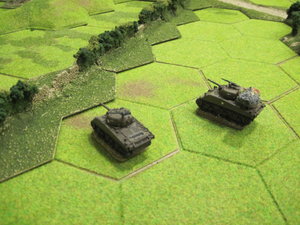 Shermans cross the open ground and one falls victim to the PAK-40