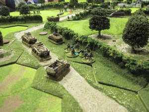 German Half tracks and infantry set up a second defensive line and prepare for an attack along the road.