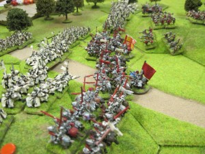 The heavy knights of both armies charge into each other in the centre