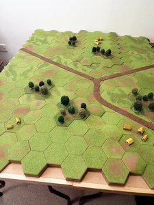 Scattered woodland and settlements dot the table